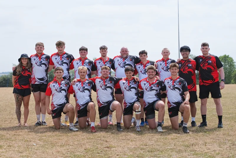 The TR7 squad together on the pitch at the Hamplified Charity 7s in their red, white and black kit